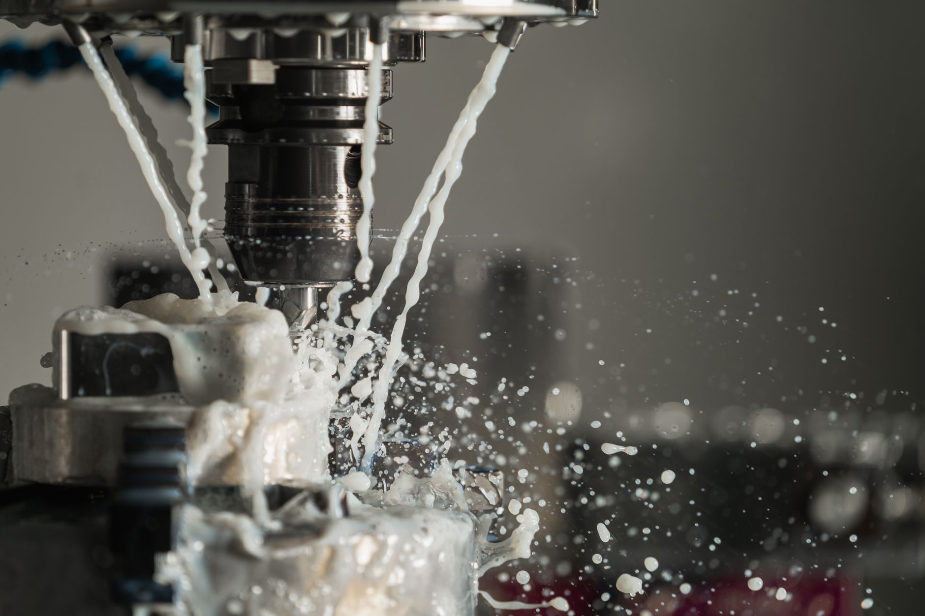 CNC machine cutting metal with coolant flowing