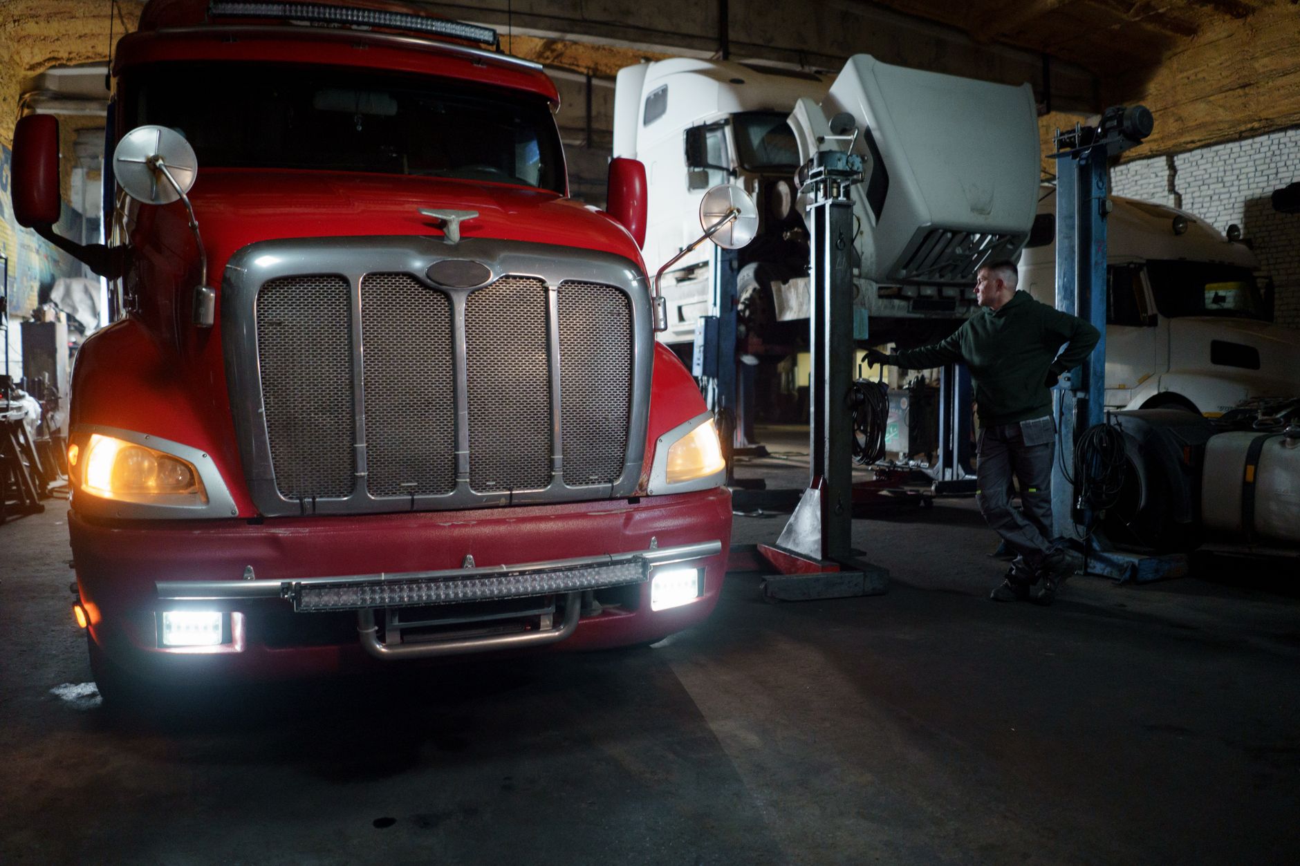 Truck raised in a workshop bay for body and structural work